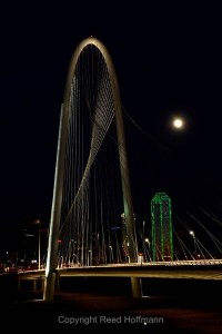 I framed this to balance the vertical shape of the bridge, the building and the rising moon. Nikon D5200 set to white balance of SUNNY and ISO of 100, shutter speed of 8 seconds at f/16, with exposure compensation at  0.0, 17-55mm f/2.8 lens. Photo copyright Reed Hoffmann.