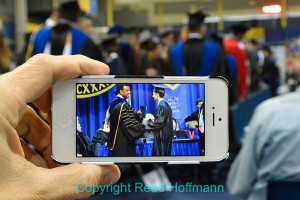 The photo of Nathan getting his degree from the chancellor, after I transmitted it to his mom's iPhone. Photo copyright Reed Hoffmann.
