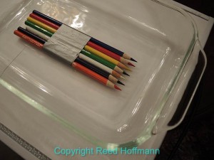 The pencils were put in a glass casserole dish, weighted down, then covered with carbonated water. (Photo copyright Reed Hoffmann)