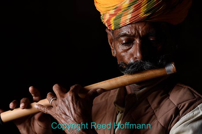 AF-S uses a single AF sensor (or point). It's good for non-moving subjects, like this musician in India. Nikon D7200, Aperture Priority, ISO 400, 1/200 at f3.5, EV -3.0, Nikkor 70-200mm f/2.8 lens at 80mm. Photo copyright Reed Hoffmann.