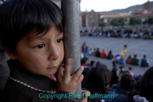 This boy was watching a parade in the town square at Cusco. Nikon D200, ISO 100, 1/20 at f/4.0, EV -0.3, Nikkor 16-35mm lens at 17mm. Photo copyright Reed Hoffmann.